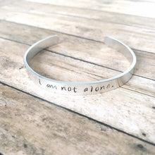 Load image into Gallery viewer, I am not alone hand stamped affirmation bangle bracelet