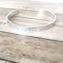 Load image into Gallery viewer, I am not alone hand stamped affirmation bangle bracelet