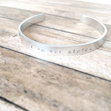 Load image into Gallery viewer, I am not alone hand stamped affirmation bangle bracelet