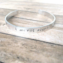 Load image into Gallery viewer, I am not alone hand stamped affirmation bangle bracelet